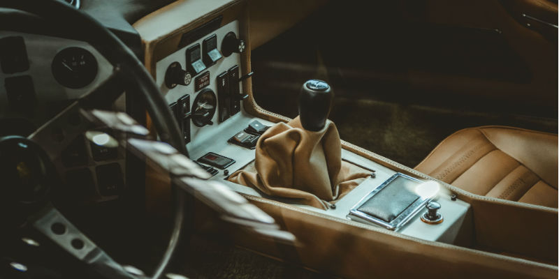 The interior of a car, including the steering wheel and gear stick