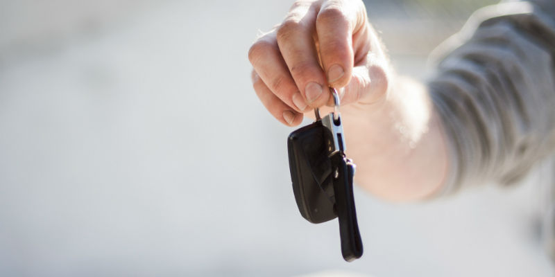 Mechanic passing over car keys to customer