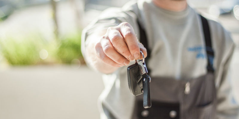 Mechanic handing over car keys to customer